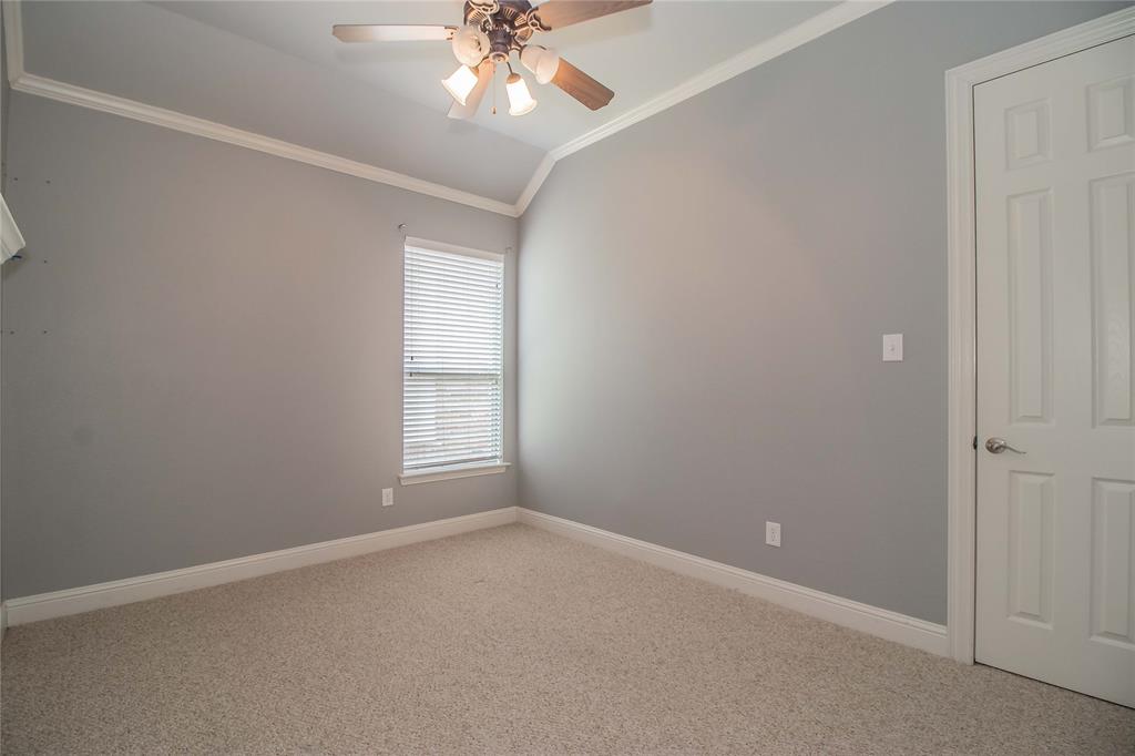 4647 Phillip Drive Plano, TX 75024 - Photo 26 of 38 an empty room with a chandelier fan and windows