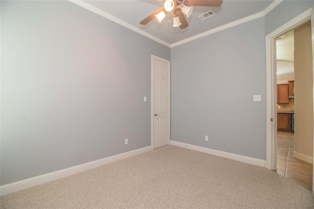 4647 Phillip Drive Plano, TX 75024 - Photo 27 of 38 an empty room with a chandelier fan and windows