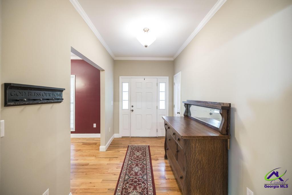 204 Smith Road Haddock, GA 31033 - Photo 6 of 51 a hallway with closet and wooden floor