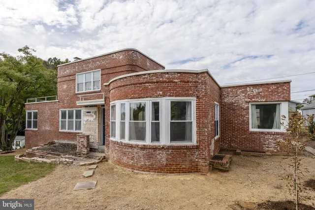 an aerial view of a house with a yard swimming pool and outdoor seating