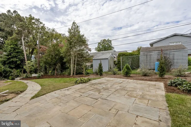 a dining room with furniture a chandelier and wooden floor
