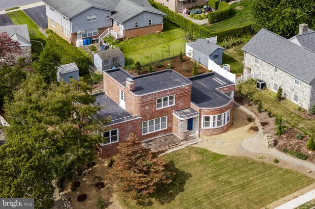 an aerial view of residential houses with yard