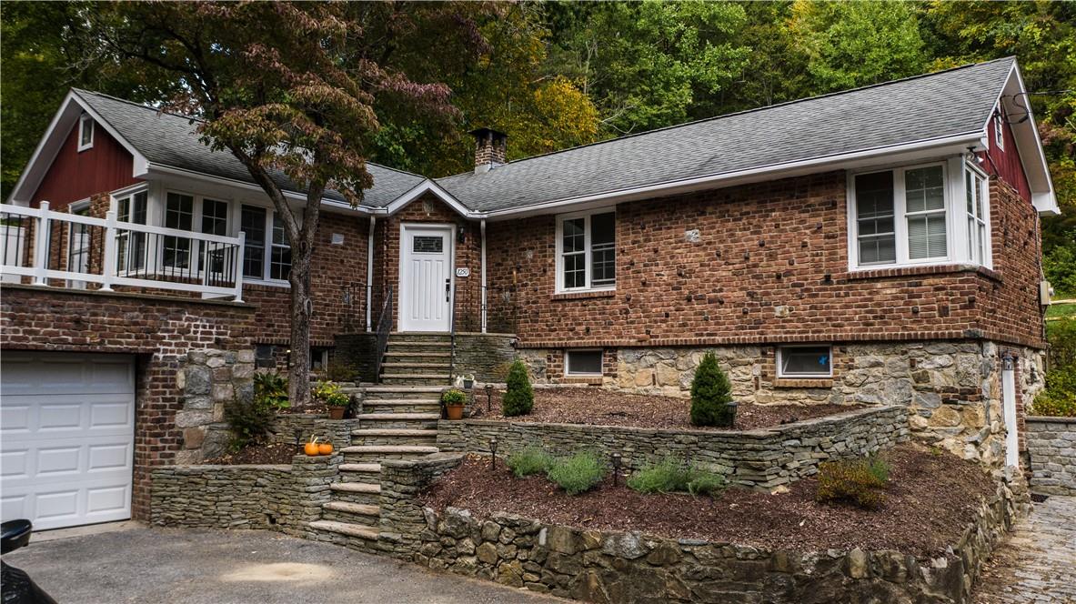 A beautiful brick home. Front door and 1 attached garage pictured.