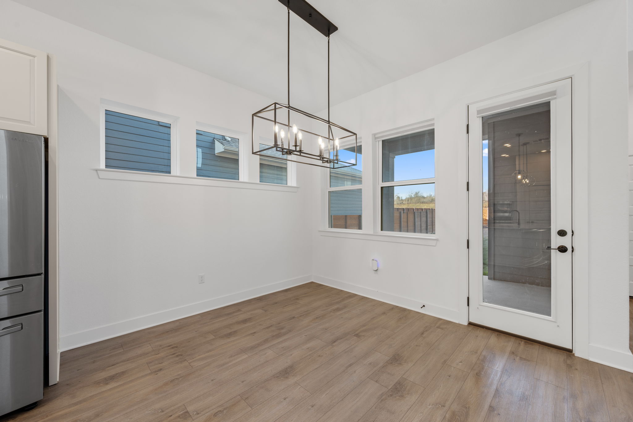 5902 Rangeland Road Austin, TX 78747 - Photo 12 of 35 Unfurnished dining area featuring light wood-style flooring and a chandelier