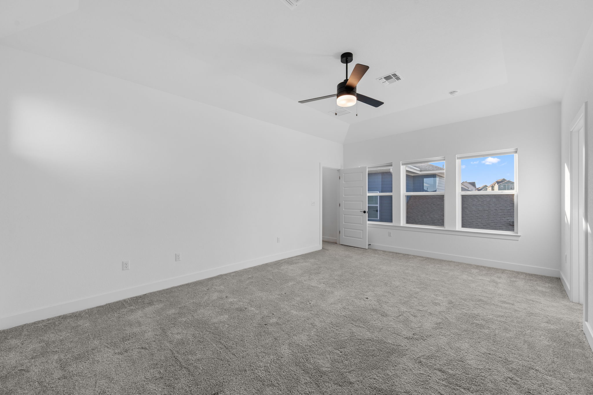 5902 Rangeland Road Austin, TX 78747 - Photo 20 of 35 Empty room with light carpet, a ceiling fan, and a tray ceiling