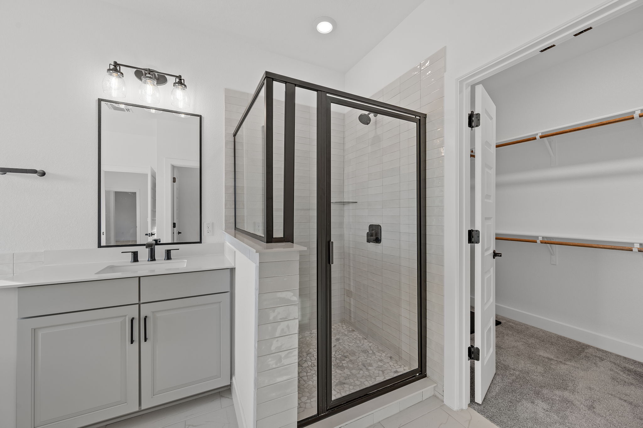 5902 Rangeland Road Austin, TX 78747 - Photo 23 of 35 Full bathroom with vanity, a stall shower, a spacious closet, and recessed lighting