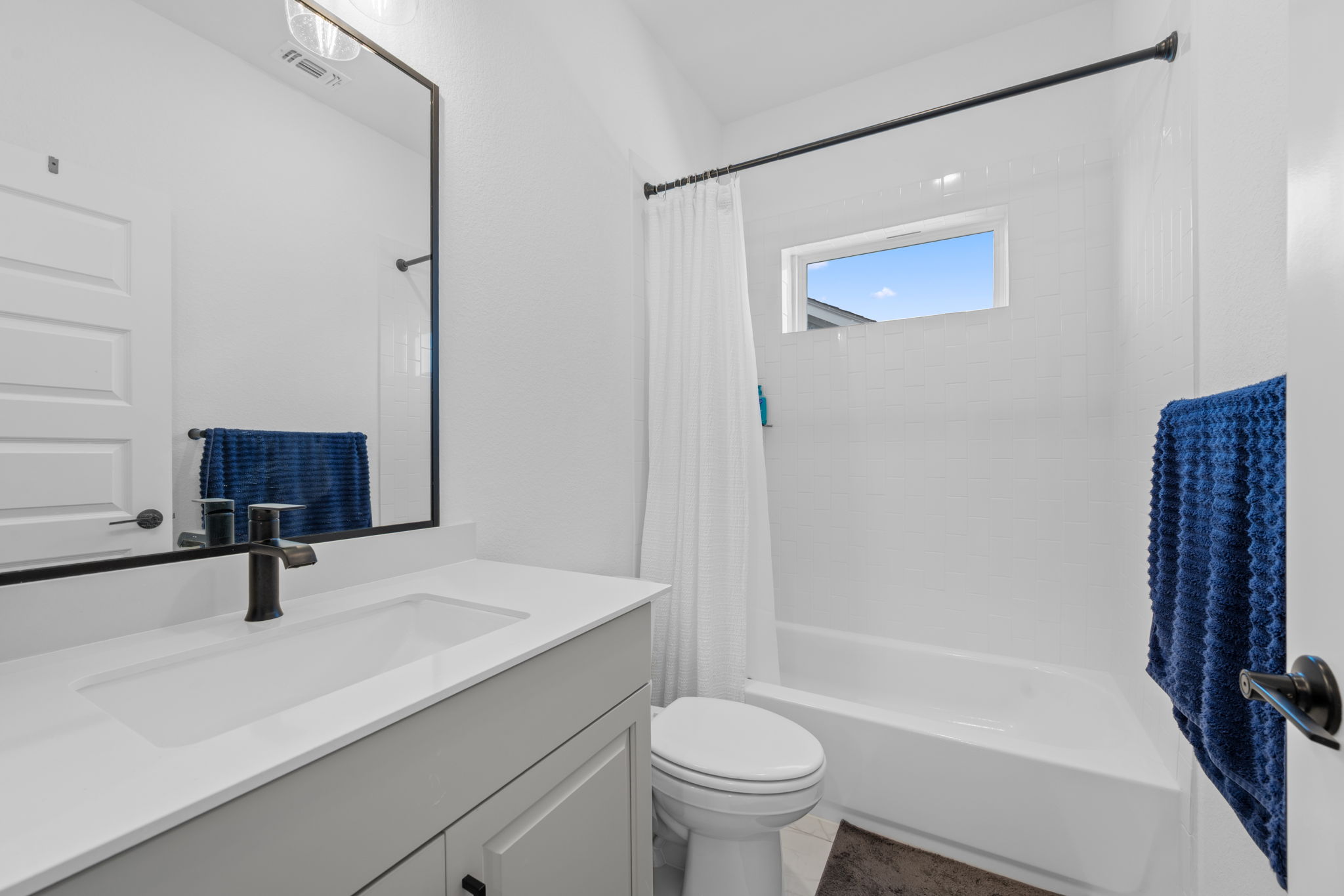 5902 Rangeland Road Austin, TX 78747 - Photo 27 of 35 Bathroom with vanity and shower / bath combo with shower curtain