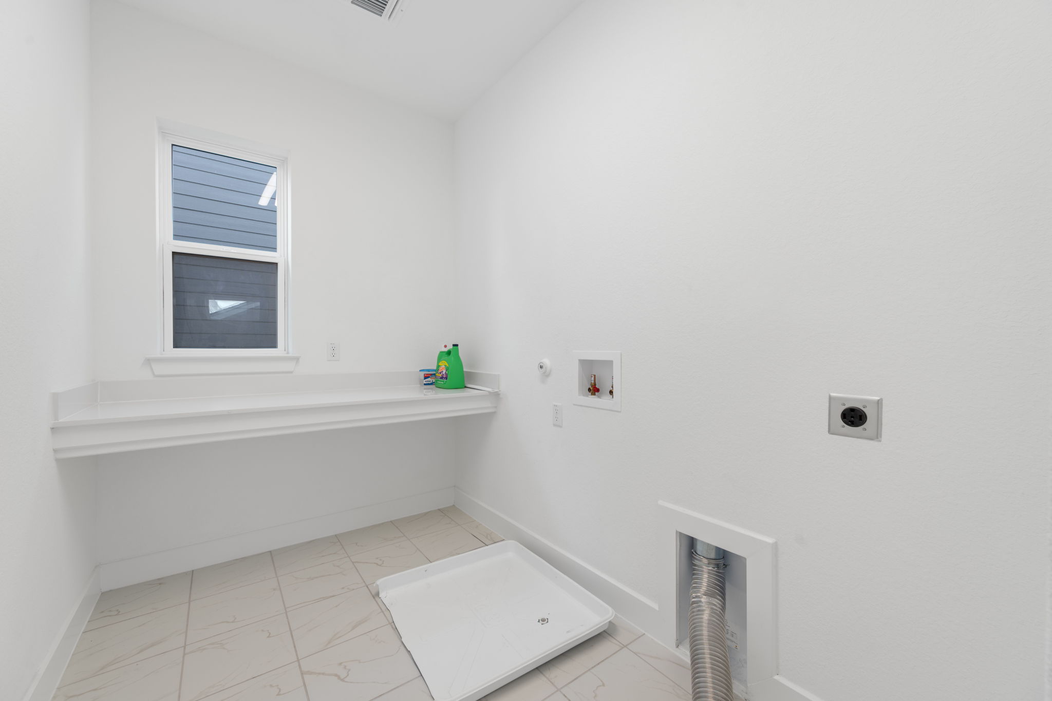 5902 Rangeland Road Austin, TX 78747 - Photo 30 of 35 Laundry area with hookup for a gas dryer, light marble finish flooring, hookup for a washing machine, and hookup for an electric dryer