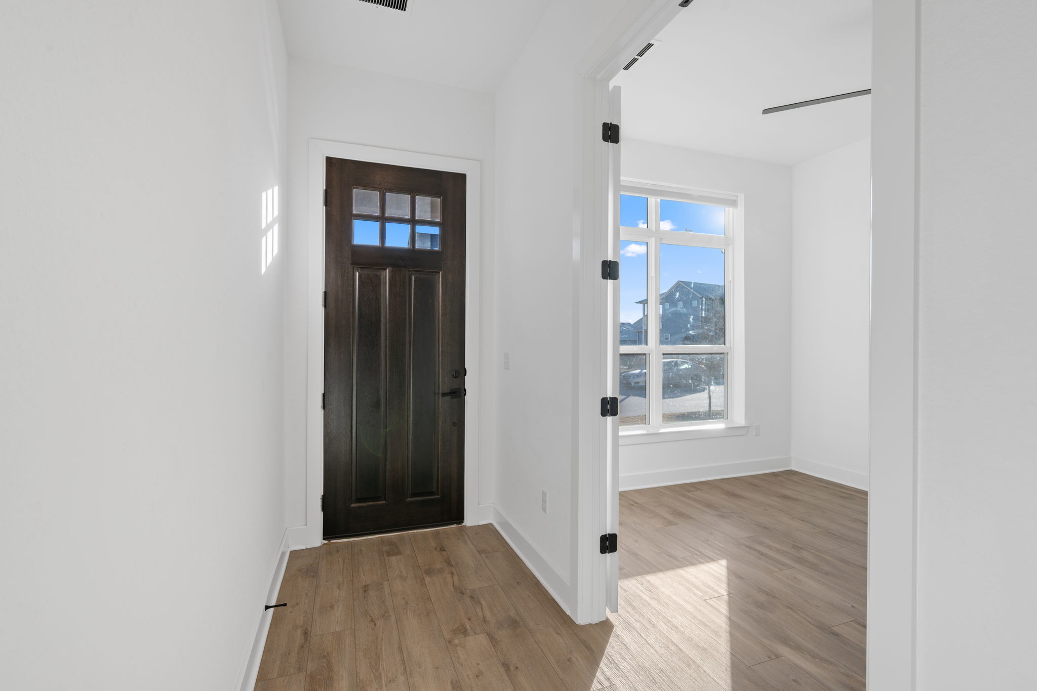 5902 Rangeland Road Austin, TX 78747 - Photo 3 of 35 Foyer entrance featuring light wood finished floors and baseboards