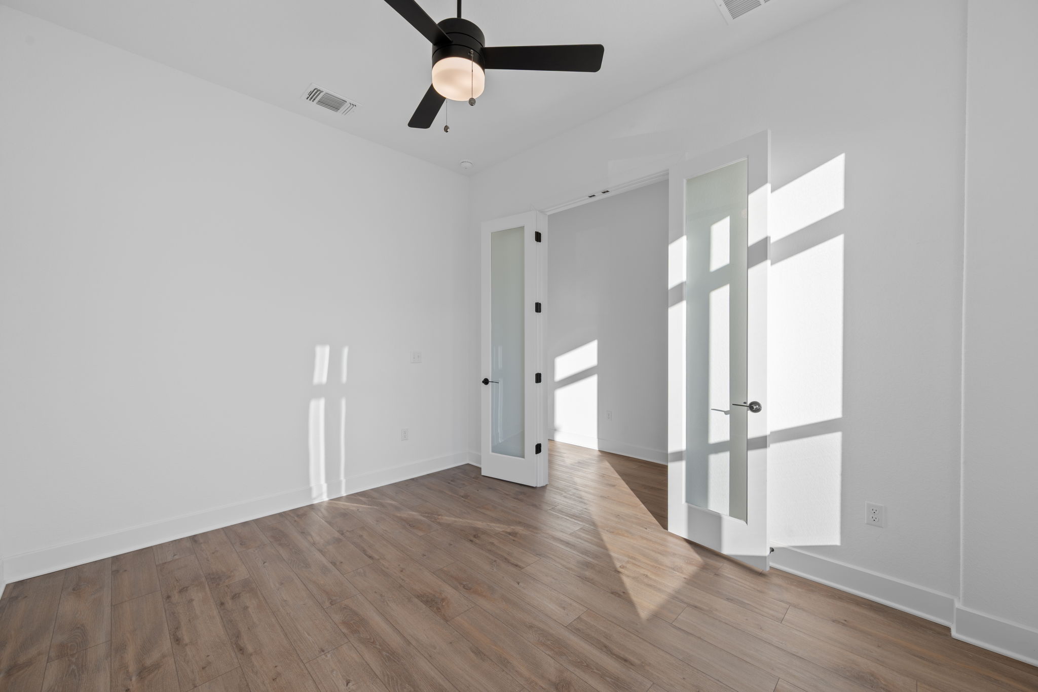 5902 Rangeland Road Austin, TX 78747 - Photo 5 of 35 Spare room featuring wood finished floors and a ceiling fan