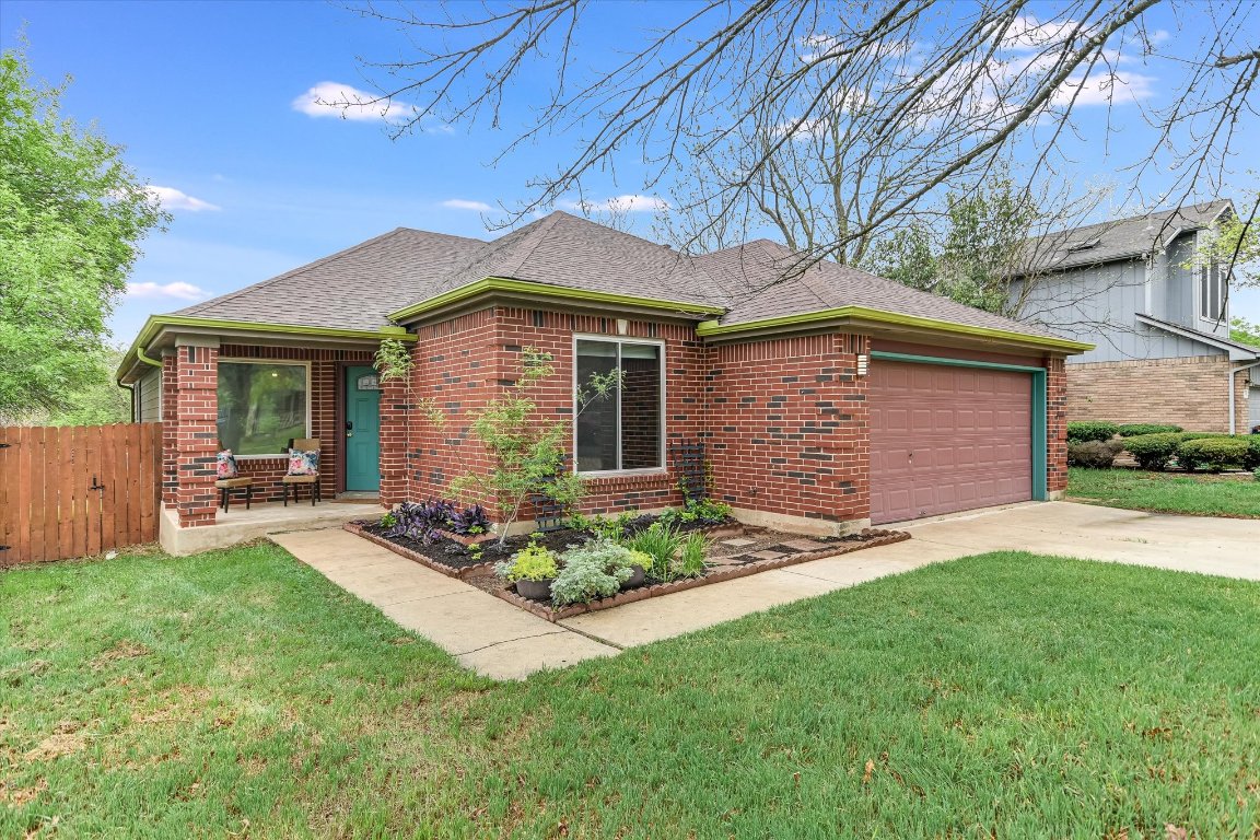 2215 Patsy Parkway Austin, TX 78744 - Photo 1 of 1 a front view of a house with a garden and yard