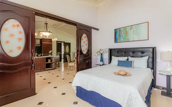 a bedroom with a bed dresser and a window