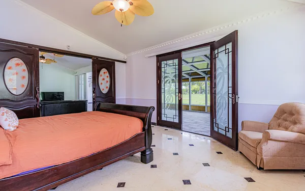 a bed sitting in a bedroom next to a window