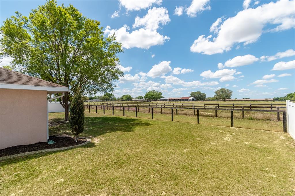 6314 Southwest 64th Avenue Ocala, FL 34474 - Photo 1 of 1 a view of a swimming pool with an outdoor seating and a yard