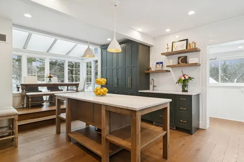 a kitchen with a table chairs and a refrigerator