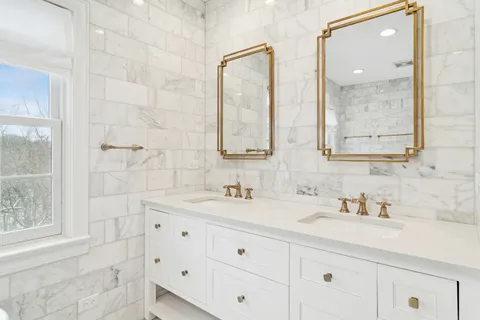 a bathroom with double sink and a mirror