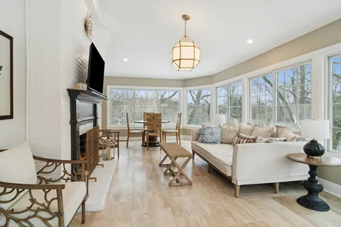 a living room with furniture fireplace and flat screen tv