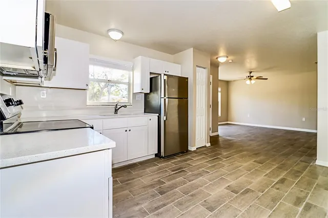 a kitchen with a sink a refrigerator and a stove