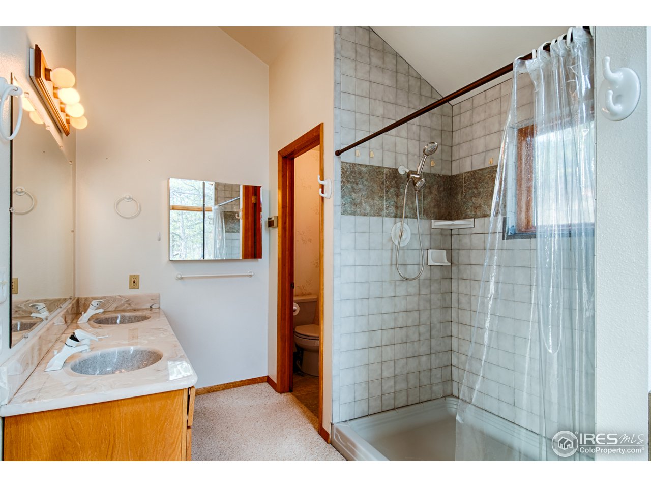 601 Eagle Ridge Road Longmont, CO 80503 - Photo 14 of 40 a bathroom with a sink and a mirror