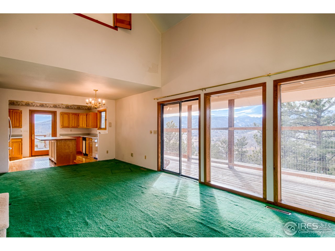 601 Eagle Ridge Road Longmont, CO 80503 - Photo 18 of 40 a view of an empty room with kitchen view and a window