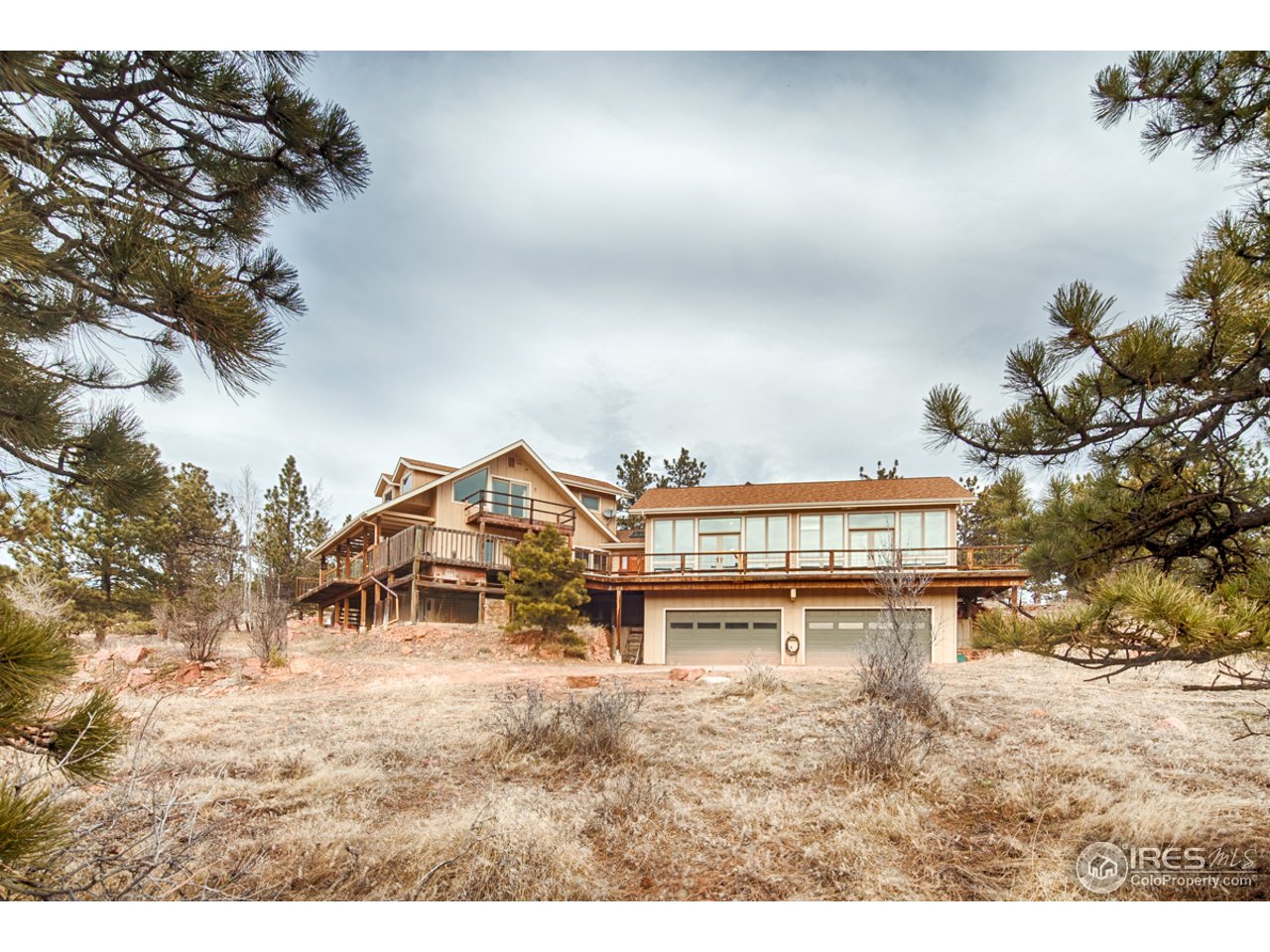 601 Eagle Ridge Road Longmont, CO 80503 - Photo 2 of 40 a view of a house with a yard and a pond