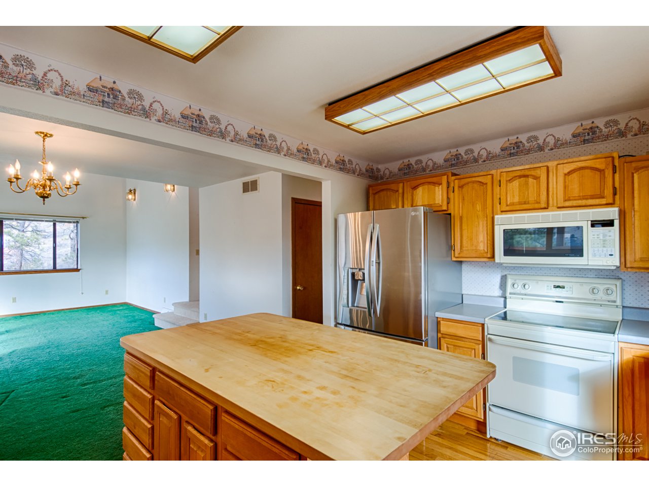 601 Eagle Ridge Road Longmont, CO 80503 - Photo 23 of 40 a kitchen that has a lot of cabinets and a wooden floor