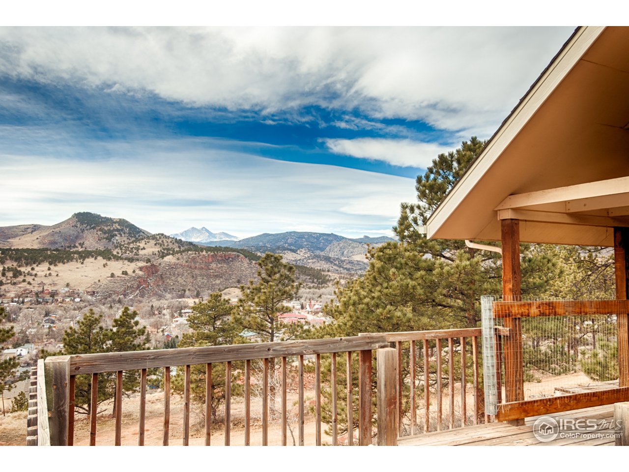 601 Eagle Ridge Road Longmont, CO 80503 - Photo 3 of 40 a view of a balcony with wooden floor and a mountain view