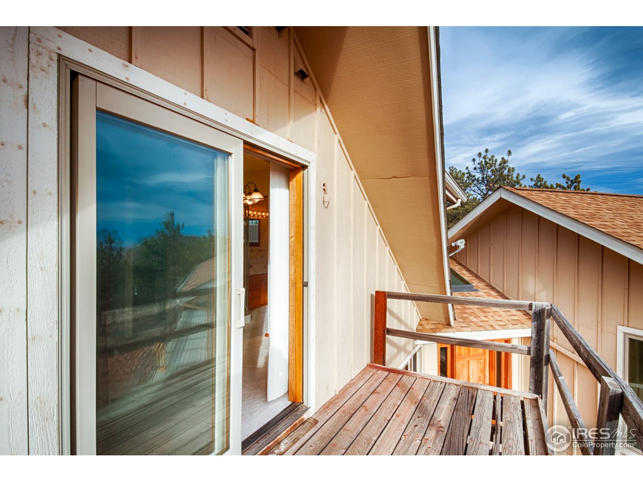 601 Eagle Ridge Road Longmont, CO 80503 - Photo 32 of 40 a view of balcony with wooden floor and door