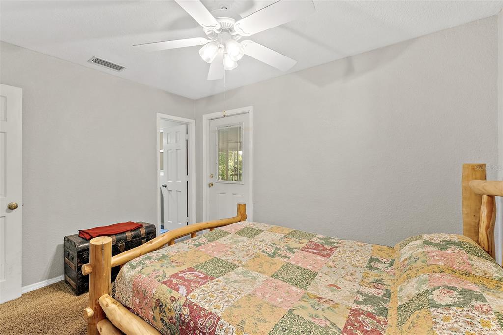 405 North Cherry Street Bunnell, FL 32110 - Photo 11 of 52 a bedroom with a bed and a chandelier