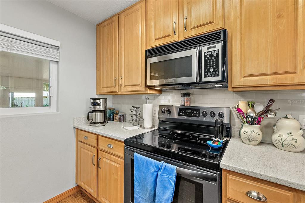 405 North Cherry Street Bunnell, FL 32110 - Photo 21 of 52 a kitchen with a stove and a microwave