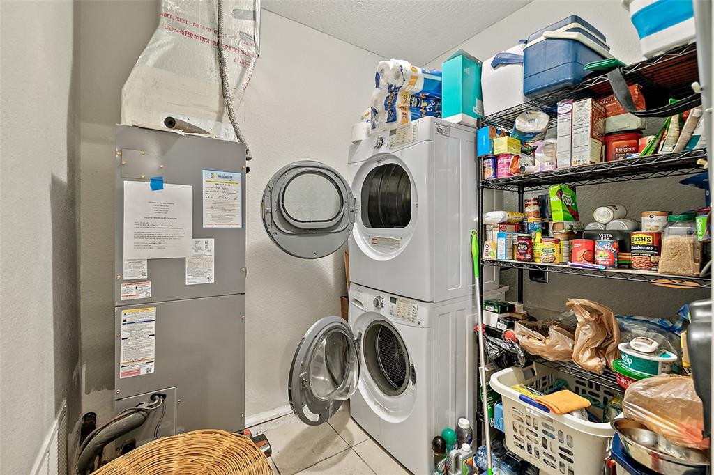 405 North Cherry Street Bunnell, FL 32110 - Photo 23 of 52 a utility room with dryer washer and a view of living room