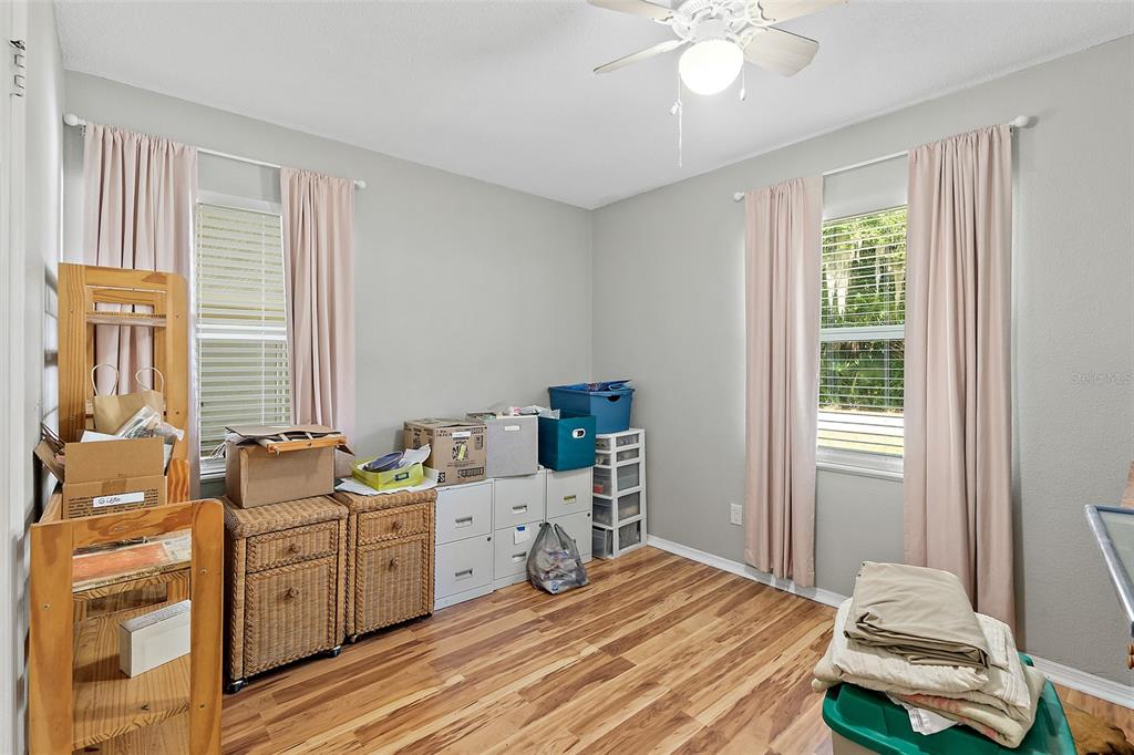 405 North Cherry Street Bunnell, FL 32110 - Photo 4 of 52 a room with a bed and a chandelier