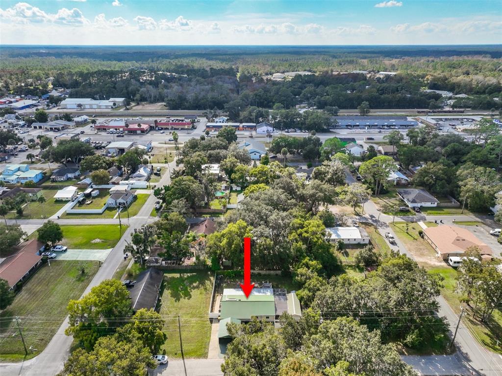 405 North Cherry Street Bunnell, FL 32110 - Photo 44 of 52 an aerial view of residential houses with outdoor space and trees