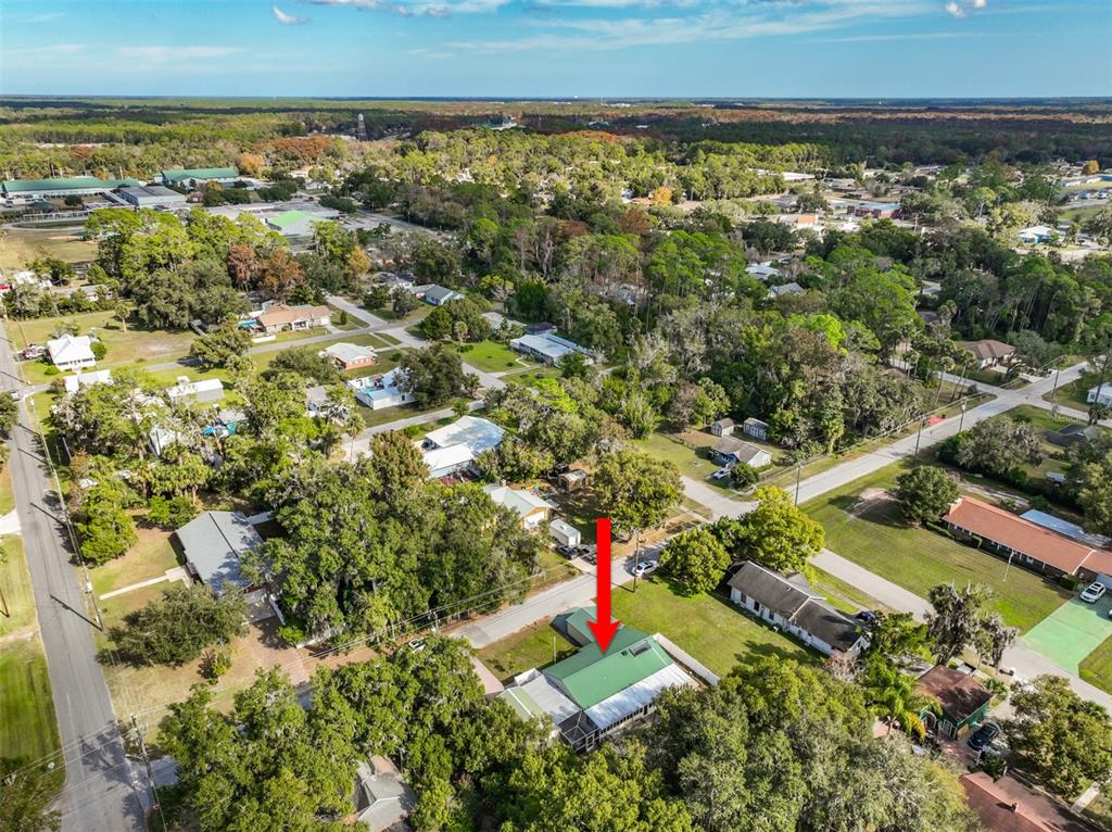 405 North Cherry Street Bunnell, FL 32110 - Photo 47 of 52 an aerial view of residential houses with outdoor space and trees