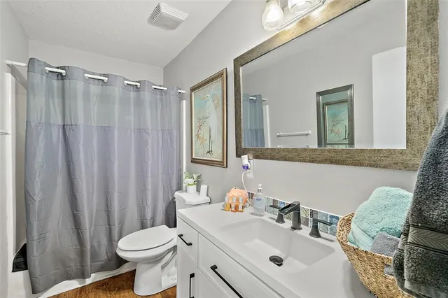 a bathroom with a sink toilet and shower