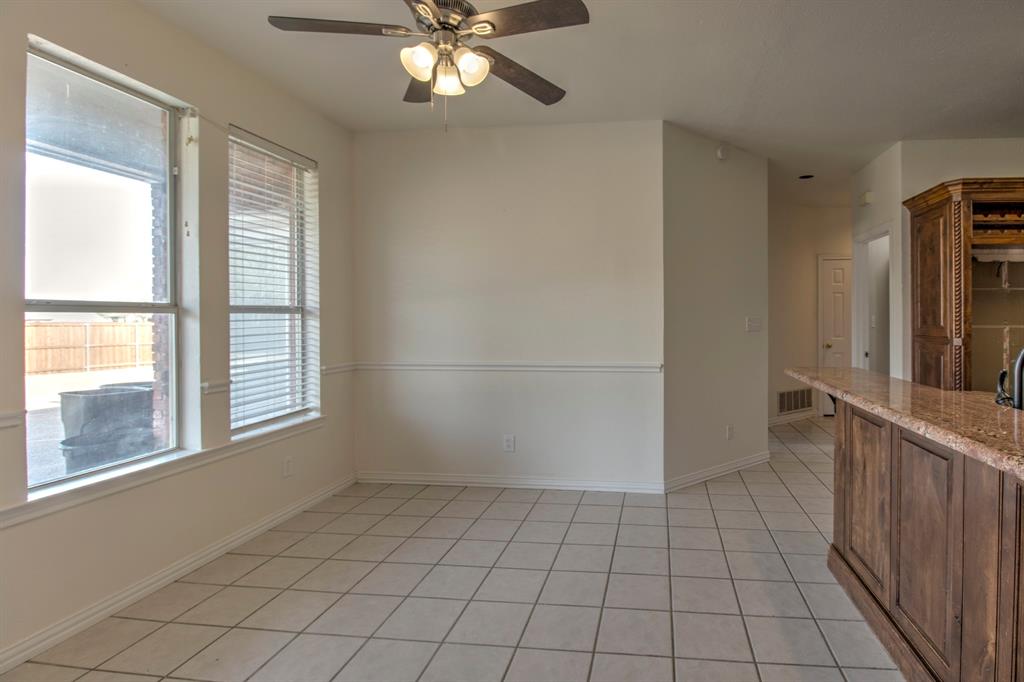 1400 North St Charles Street Pilot Point, TX 76258 - Photo 14 of 30 a view of an empty room with window and chandelier fan