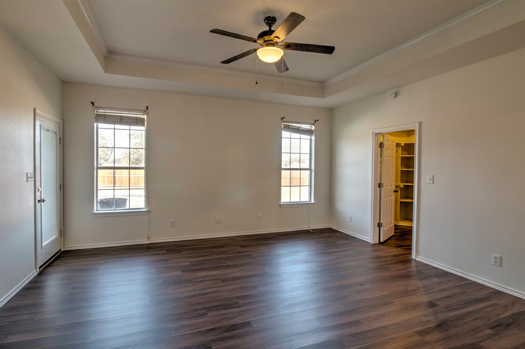1400 North St Charles Street Pilot Point, TX 76258 - Photo 15 of 30 a view of empty room with wooden floor and fan