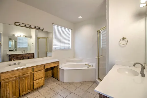 a bathroom with a tub sink and mirror