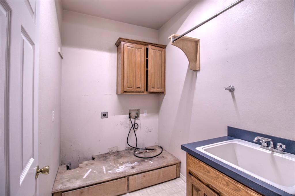 1400 North St Charles Street Pilot Point, TX 76258 - Photo 20 of 30 a bathroom with a sink and a mirror