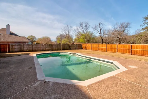 a view of a swimming pool with an outdoor seating and a yard