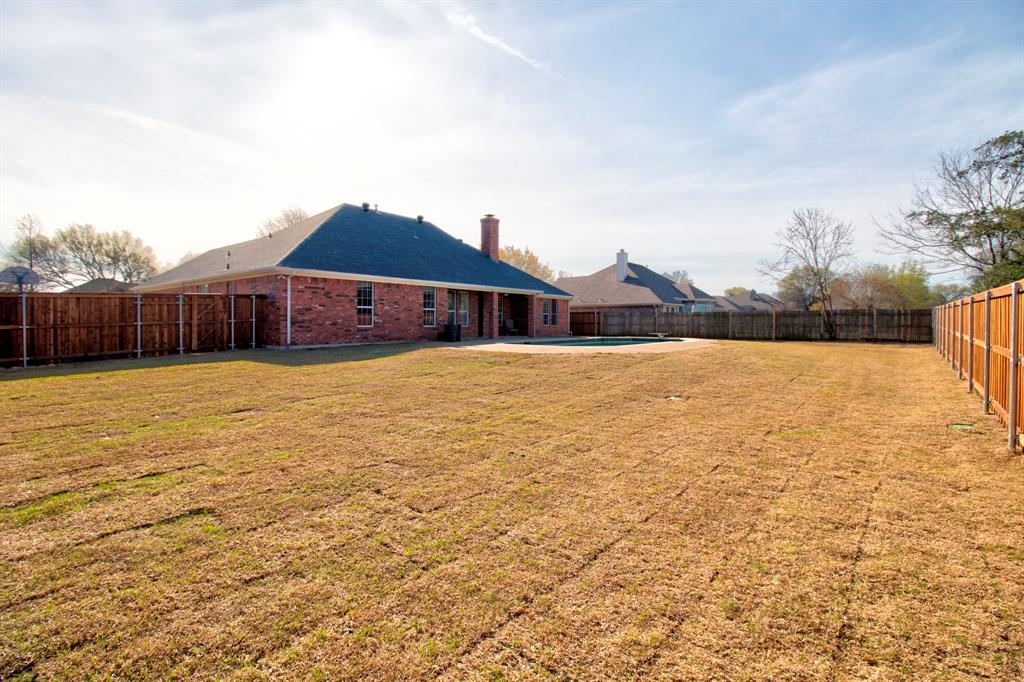 1400 North St Charles Street Pilot Point, TX 76258 - Photo 29 of 30 a view of a house with a yard and a large tree