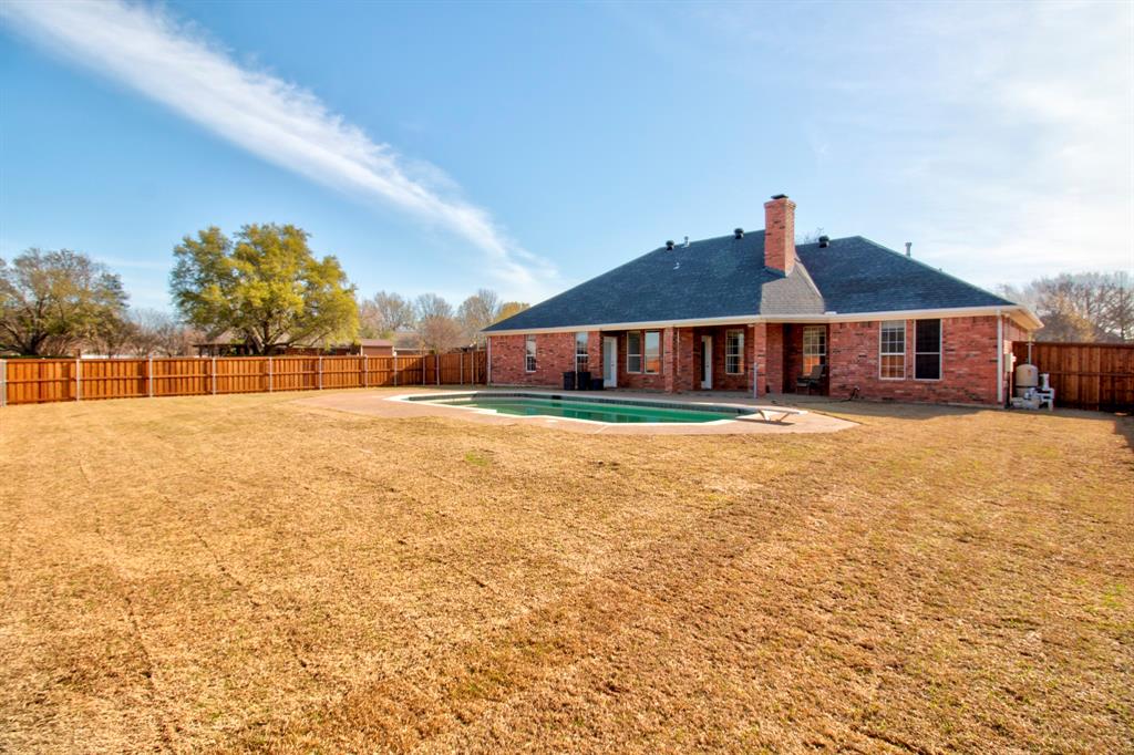 1400 North St Charles Street Pilot Point, TX 76258 - Photo 30 of 30 a view of a house with a yard