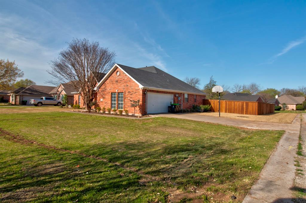 1400 North St Charles Street Pilot Point, TX 76258 - Photo 3 of 30 a front view of a house with garden