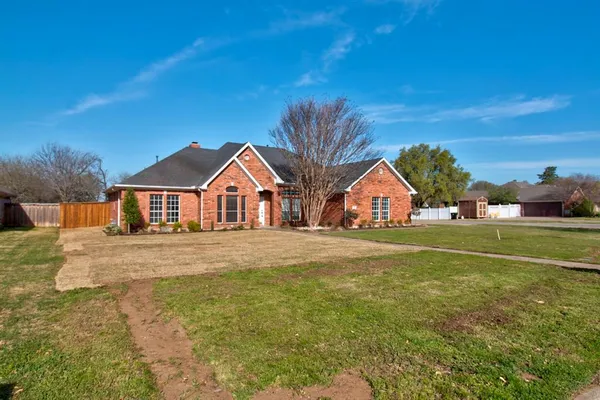 a view of big yard in front of house with a yard