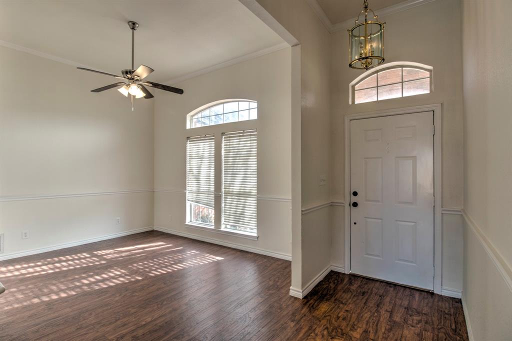 1400 North St Charles Street Pilot Point, TX 76258 - Photo 5 of 30 a view of empty room with wooden floor and fan