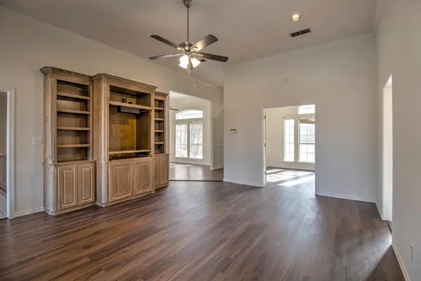 a view of wooden floor and windows in a room