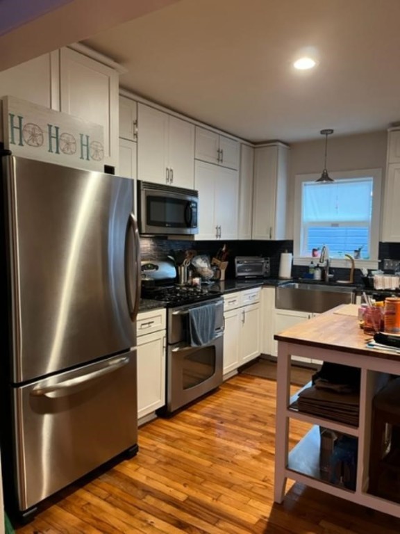 Undisclosed Address Austin, TX 78704 - Photo 9 of 10 a kitchen with stainless steel appliances and a refrigerator