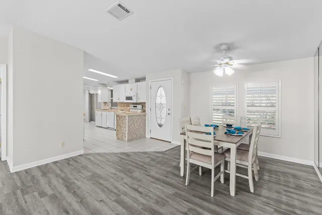 a large kitchen with cabinets a sink a window and stainless steel appliances