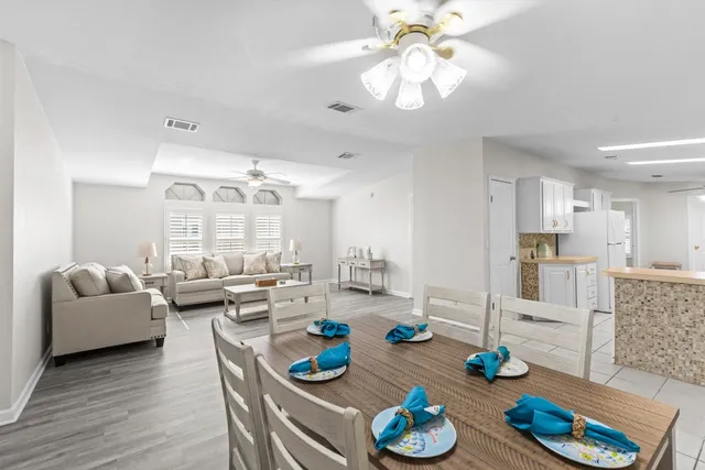 a kitchen with a sink a stove a refrigerator and white cabinets