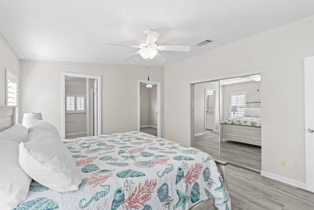 an empty room with wooden floor and window